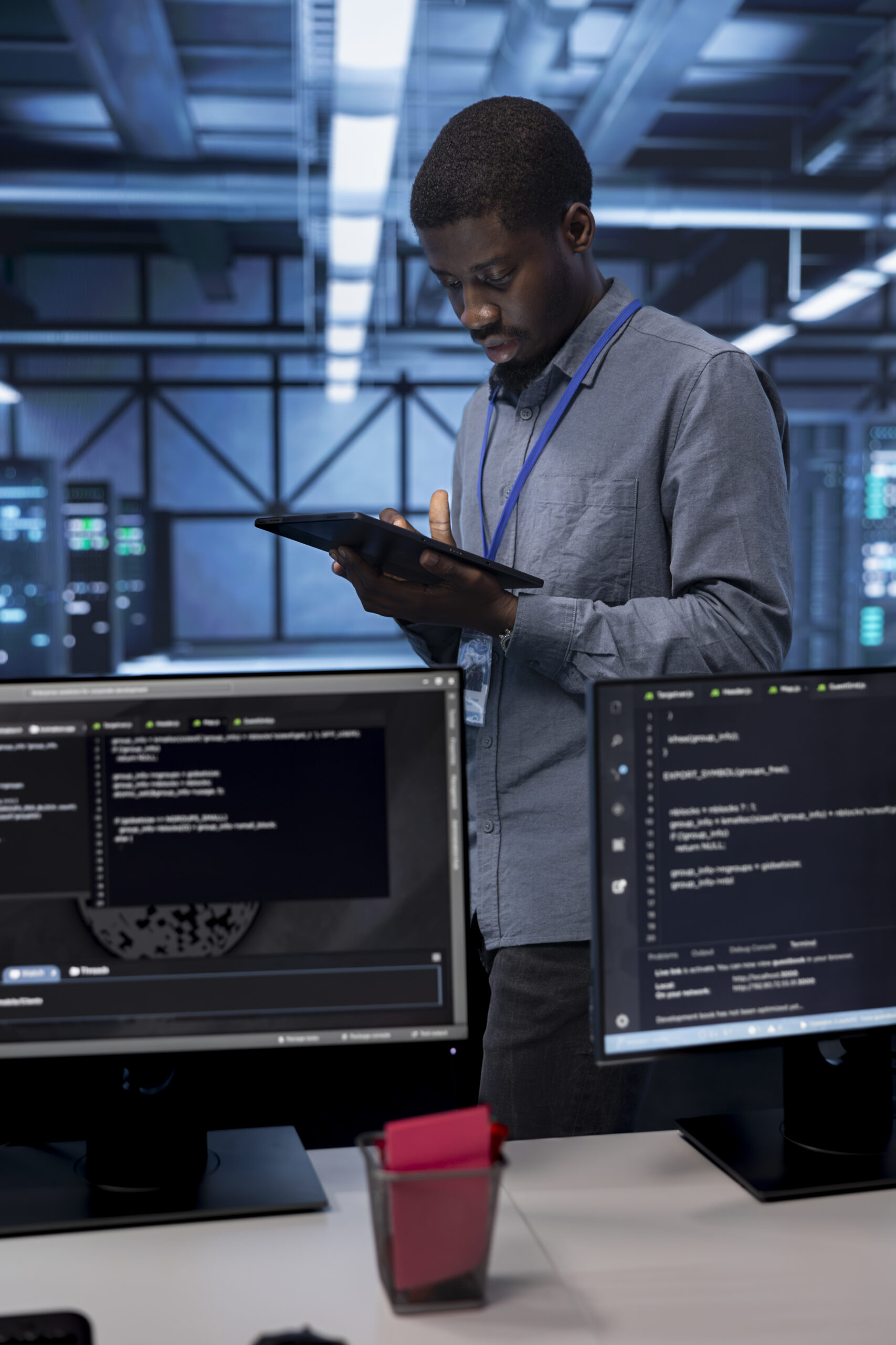 Admin in data center using system monitoring software on tablet device