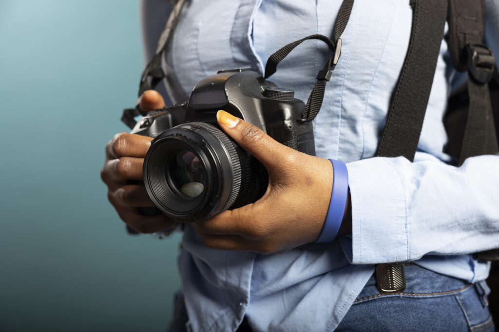 Closeup of person holding dslr camera